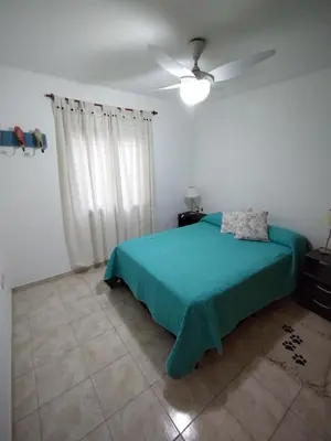 a bedroom with a green bed and a ceiling fan at Departamento Boutique in Cordoba