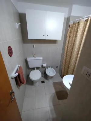 a small bathroom with a toilet and a sink at Departamento Boutique in Cordoba