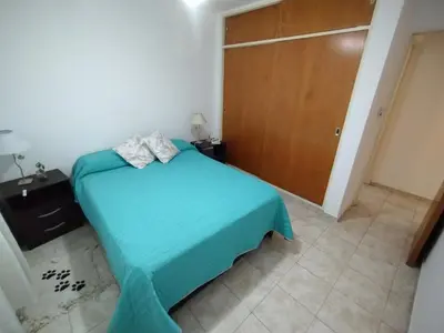 a bedroom with a blue bed and a wooden door at Departamento Boutique in Cordoba