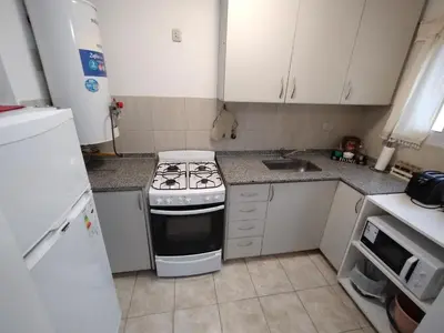 a small kitchen with a stove and a sink at Departamento Boutique in Cordoba
