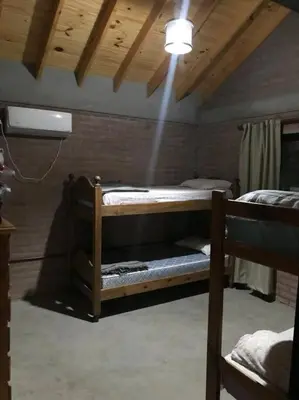 a room with two bunk beds and a light at Cabaña CABEZA DE NIEVE Apta 6 personas in Carpintería
