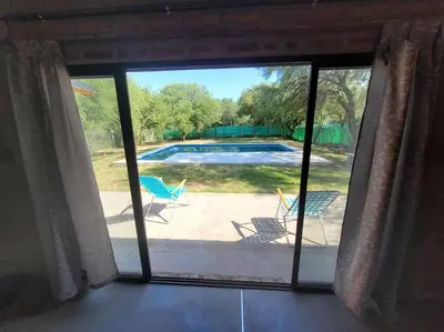 a view from a window of a patio with a pool at Cabaña CABEZA DE NIEVE Apta 6 personas in Carpintería