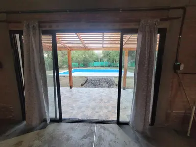 a sliding glass door with a view of a pool at Cabaña CABEZA DE NIEVE Apta 6 personas in Carpintería