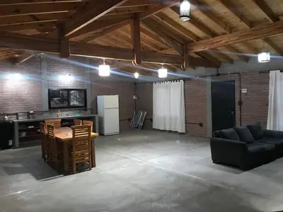 a large living room with a table and a couch at Cabaña CABEZA DE NIEVE Apta 6 personas in Carpintería