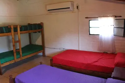 a room with two bunk beds and a window at Complejo Salamanca - Cabaña La Catalana in Trapiche