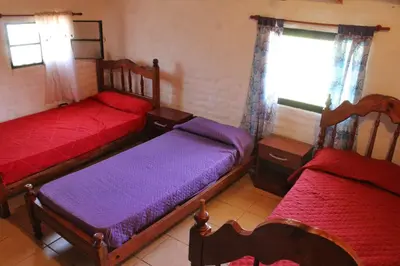 a bedroom with two beds and a window at Complejo Salamanca - Cabaña La Catalana in Trapiche