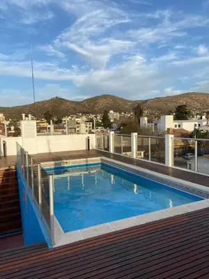 a swimming pool on the roof of a building at Departamento Edificio Manantiales in Villa Carlos Paz