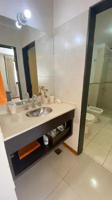 a bathroom with a sink and a toilet at Departamento Edificio Manantiales in Villa Carlos Paz