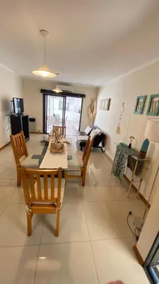 a living room with a dining room table and chairs at Departamento Edificio Manantiales in Villa Carlos Paz