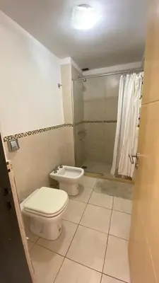 a bathroom with a toilet and a shower at Departamento Edificio Manantiales in Villa Carlos Paz