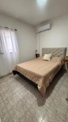 a bedroom with a large bed in a room at 760 D Apartamentos in Alta Gracia