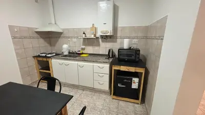 a small kitchen with a sink and a microwave at 760 D Apartamentos in Alta Gracia