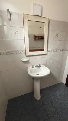 a bathroom with a sink and a mirror at 760 D Apartamentos in Alta Gracia