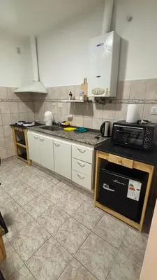 a kitchen with a sink and a stove top oven at 760 D Apartamentos in Alta Gracia