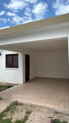 a white house with a garage at 760 D Apartamentos in Alta Gracia