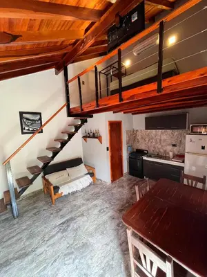 a room with a loft with a bed and a staircase at Eurotrip in Mina Clavero