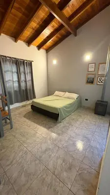 a bedroom with a bed in the corner of a room at Eurotrip in Mina Clavero
