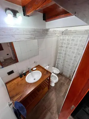 a bathroom with two toilets and a sink at Eurotrip in Mina Clavero