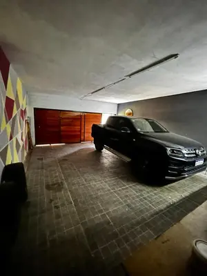 a black car is parked in a garage at Eurotrip in Mina Clavero