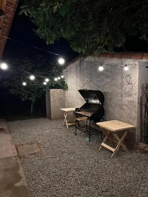a piano sitting next to a table and a bench at Eurotrip in Mina Clavero