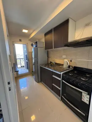a kitchen with a stove and a refrigerator at Departamento en terra forte 1 in Cordoba