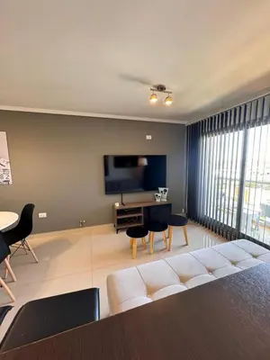 a living room with a couch and a flat screen tv at Departamento en terra forte 1 in Cordoba