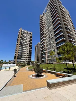 two tall buildings in a city with a park at Departamento en terra forte 1 in Cordoba