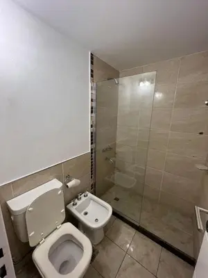 a bathroom with a toilet and a shower at Departamento en terra forte 1 in Cordoba