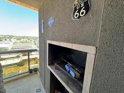 an outdoor pizza oven in a building with a view at Departamento en terra forte 1 in Cordoba
