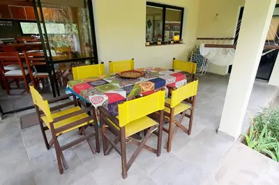 a dining room table with yellow chairs around it at Hermosa casa con pileta para dos in Villa General Belgrano