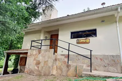 a house with a staircase in front of it at Hermosa casa con pileta para dos in Villa General Belgrano