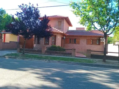 a large brick house on a street at La casa de Yari in Mina Clavero