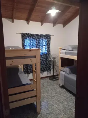 a room with two bunk beds and a window at La casa de Yari in Mina Clavero