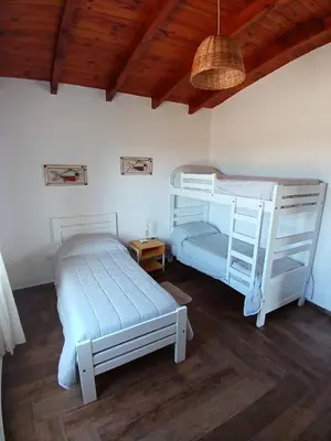 a bedroom with two bunk beds and a wooden ceiling at La Toscana in Villa Yacanto