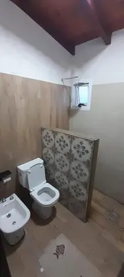 a bathroom with a toilet and a sink at La Toscana in Villa Yacanto