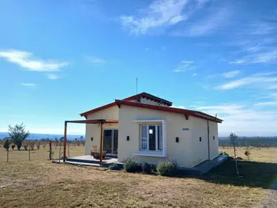 a small house in the middle of a field at La Toscana in Villa Yacanto