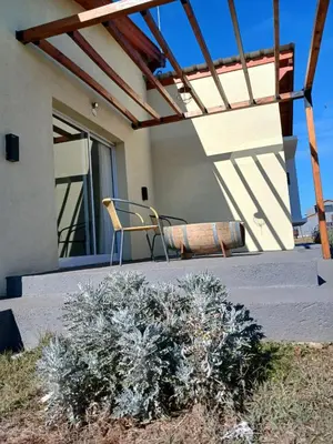 a patio with a chair and a plant at La Toscana in Villa Yacanto