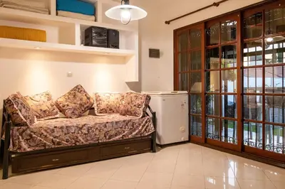 a couch sitting in a living room next to a window at Casa con pileta exclusiva a 3 cuadras de la costanera Villa Carlos Paz IG alquilervillacarlospaz in Villa Carlos Paz