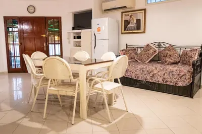 a dining room with a table and chairs and a couch at Casa con pileta exclusiva a 3 cuadras de la costanera Villa Carlos Paz IG alquilervillacarlospaz in Villa Carlos Paz