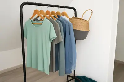 a rack with shirts and a basket on it at Atenea Residence in Cordoba
