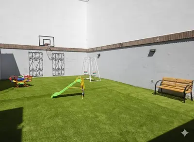 a playground with a bench and a basketball hoop at Atenea Residence in Cordoba