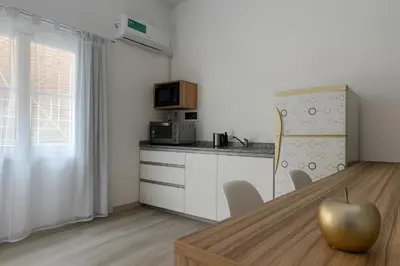 a kitchen with a table with a apple on top of it at Atenea Residence in Cordoba