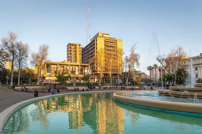 a fountain in the middle of a city with buildings at Atenea Residence in Cordoba
