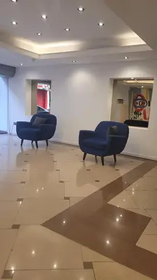 two blue ottoman chairs in a large room at MONOAMBIENTE VILAUT Temporario in Cordoba