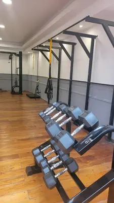 a gym with a row of dumbbells in a room at MONOAMBIENTE VILAUT Temporario in Cordoba