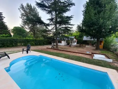 a large blue swimming pool in a yard at Casita en Villa General Belgrano in Villa General Belgrano