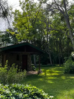 a small stone shelter in a yard with trees at Cabañas Los Hornillos de Juli y Marce in Los Hornillos