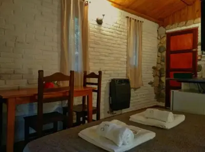 a room with a table and two chairs and a table at Cabañas Los Hornillos de Juli y Marce in Los Hornillos