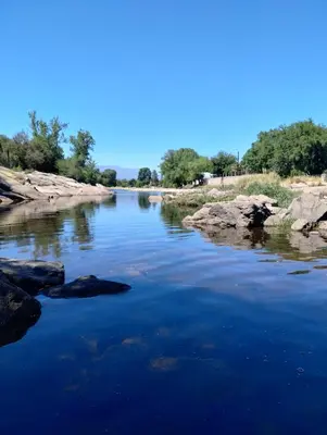 a river with rocks in the water at Torre Roca in Villa Carlos Paz