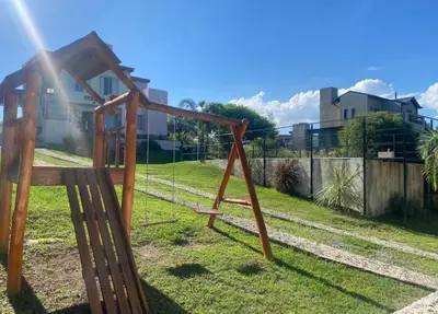 a swing set in a yard with the sun shining at Apart La Sole in Tanti